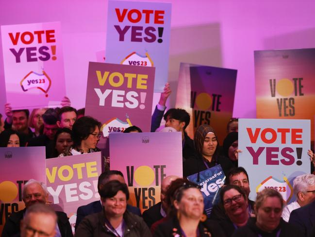 ADELAIDE, AUSTRALIA - AUGUST 30: People hold up placards during the Yes campaign launch on August 30, 2023 in Adelaide, Australia. On October 14, 2023, Australians will vote on a referendum to amend the Constitution to recognise First Peoples of Australia and establish an Aboriginal and Torres Strait Islander Voice to Parliament. To pass, the referendum requires a 'double majority'ÃÂ³ a national majority of  'yes' votes, and a majority of states voting 'yes'. (Photo by James Elsby/Getty Images)