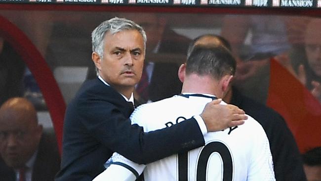 Jose Mourinho hugs Wayne Rooney of Manchester United as he is substituted.