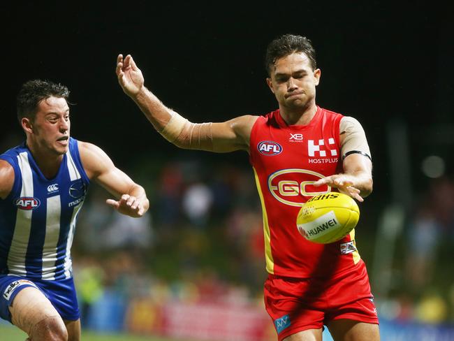 Action from the AFL match between the Gold Coast Suns and the North Melbourne Kangaroos, held at Cazalys Stadium, Cairns. Gold Coast's Jarrod Harbrow kicks down field. PICTURE: BRENDAN RADKE