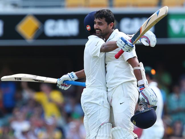 India's Murali Vijay is congratulated by teammate Ajinkya Rahane after scoring a century.