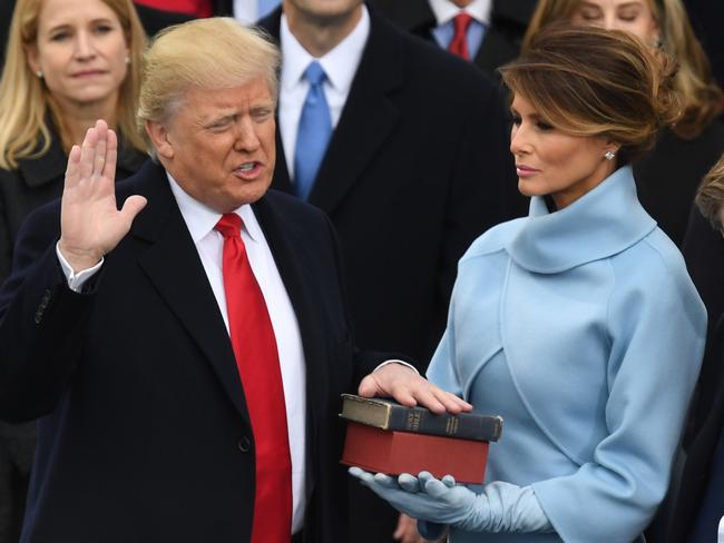 (FILES) In this file photo taken on January 20, 2017, US President-elect Donald Trump, with his wife Melania Trump, is sworn in as President at the US Capitol in Washington, DC. - Melania Trump has courted controversy with everything from her words to her clothes. At times, she has seemed less than enthralled with life in the White House. But come next week, the 50-year-old native Slovenian -- the first foreign-born first lady in two centuries -- might be extending her stay in the East Wing for another four years. Trump, the third wife of her president husband, is a former model with a dazzling gaze who has been a discreet source of support for the US leader, mostly out of the camera frame. (Photo by Mark RALSTON / AFP)