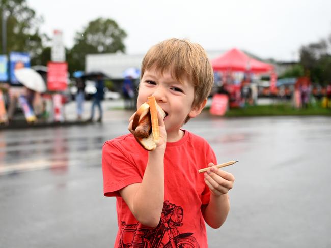 BRISBANE, AUSTRALIA - MAY 21:  Four year-old Darcy enjoys a "Democracy Sausage" after his parents voted at a polling booth in the electorate of Dixon on May 21, 2022 in Brisbane, Australia. Australians head to the polls today to elect the 47th Parliament of Australia, with a tight battle between incumbent Prime Minister Scott Morrison of the Coalition party and Labor Leader, Anthony Albanese. The Coalition party has led government since 2013. (Photo by Dan Peled/Getty Images)