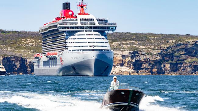 Sir Richard on his wooden speedboat, with his big ship in the background, sailing Sydney Harbour on Tuesday. Picture: Supplied