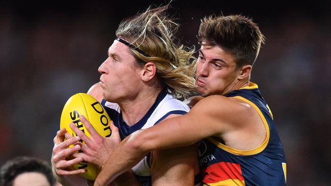 Riley Knight tackles Geelong’s Mark Blicavs at Adelaide Oval. Picture: AAP Image/David Mariuz