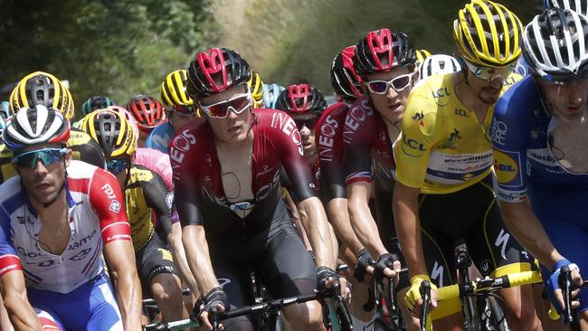 France's Julian Alaphilippe wearing the overall leader's yellow jersey rides in the pack with Britain's Geraint Thomas, centre, right, and France's Thibaut Pinot, left, during the fifteenth stage of the Tour de France cycling race over 185 kilometres (114,95 miles) with start in Limoux and finish in Prat d'Albis, France, Sunday, July 21, 2019. (AP Photo/Thibault Camus)