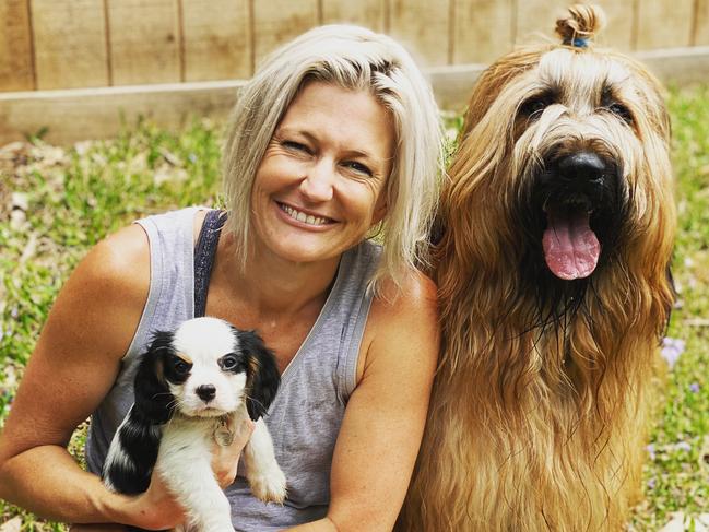 Amy Smith with her pup Calvin, a cavalier King Charles spaniel, then eight months, and Brian, three, a baird. Picture: Supplied.