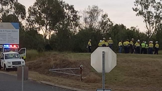 Workers gathered outside the exclusion zone at Callide Power Station near Biloela.