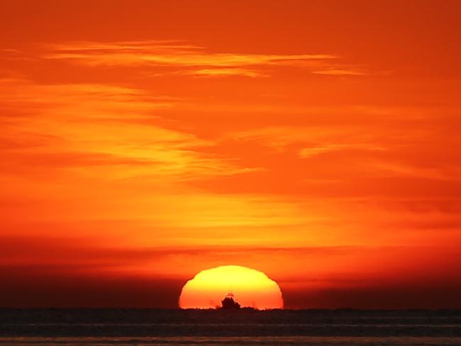 The sun rises at Chinamans Beach, Mosman, this morning. Picture: John Grainger