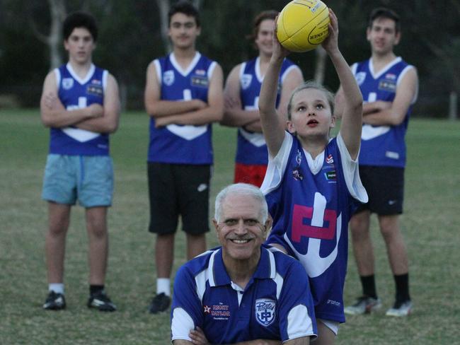 Parkmore under-12 player Sienna Alievski from takes a mark over president Michael Palma. Picture: Stuart Milligan