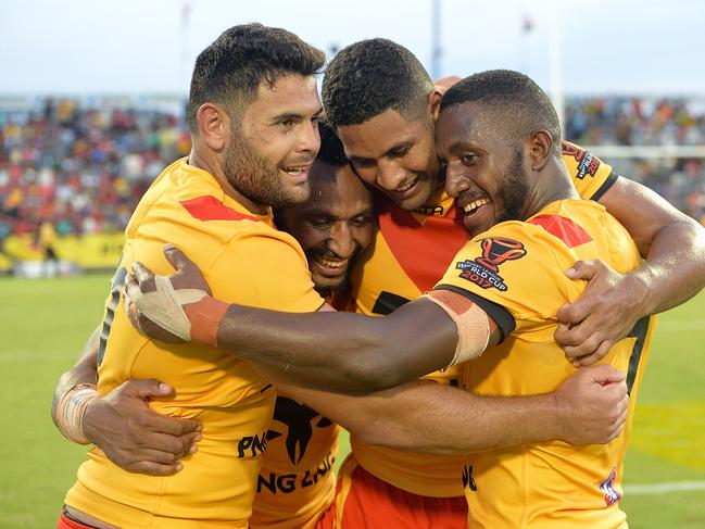 Rhyse Martin, Justin Olam, Nene McDonald and Watson Boas of Papua New Guinea celebrate victory in a 2017 Rugby League World Cup match. Picture: Bradley Kanaris/Getty Images