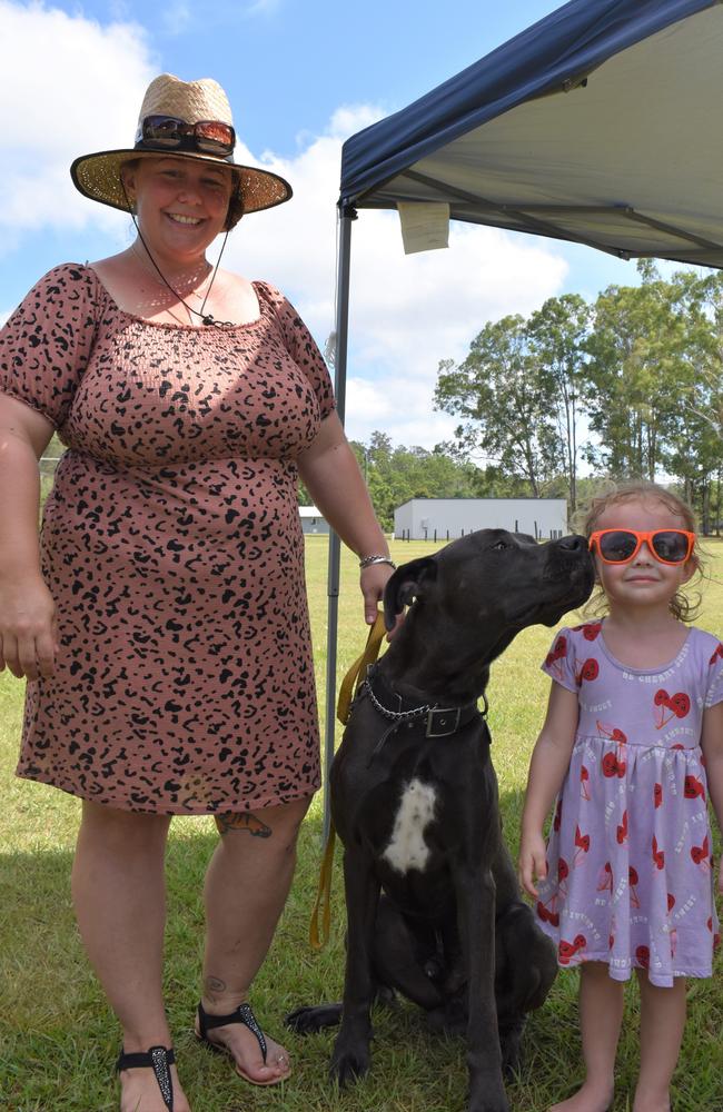 Kristy and Kyah E with their dog Judge. Judge is giving Kyah a special kiss.