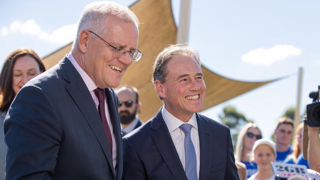 Prime Minister Scott Morrison stops outgoing health minister Greg Hunt as he almost accidentally announces his successor. Picture: Jason Edwards