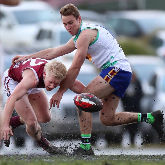 Moe’s Matthew Heywood and Traralgon’s Cooper Brown battle for the ball in the mud.