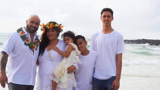 Burleigh man Joe Tongi who was injured in the surf, pictured with his wife Ebonny and their three children.