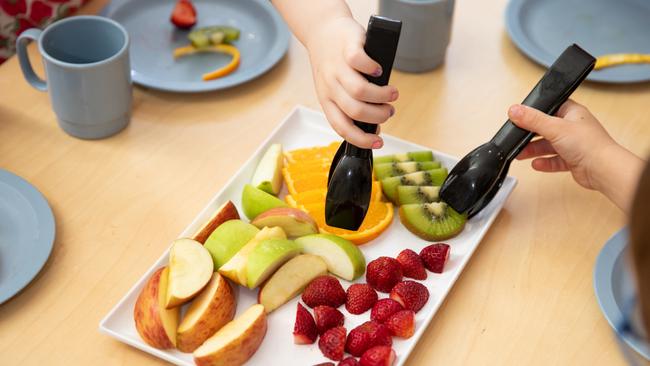 CHildren try the healthy options at Sesame Lane Care and Kindergarten.