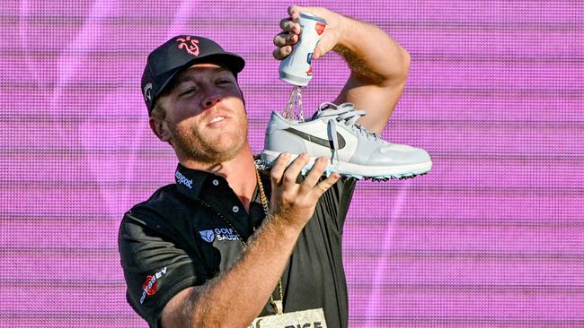 Talor Gooch celebrates with a shoey. (Photo by Brenton Edwards / AFP)