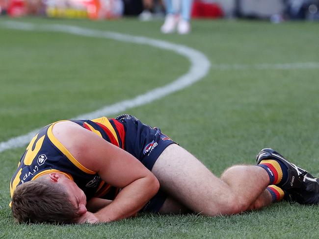 ADELAIDE, AUSTRALIA - MARCH 25: Patrick Parnell of the Crows on the ground and hurt after being tackled by Nathan Broad of the Tigers during the 2023 AFL Round 02 match between the Adelaide Crows and the Richmond Tigers at Adelaide Oval on March 25, 2023 in Adelaide, Australia. (Photo by Sarah Reed/AFL Photos via Getty Images)