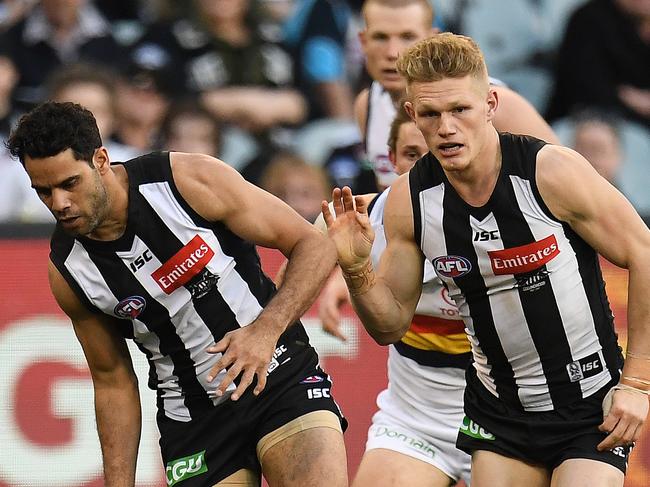 Daniel Wells (centre) and Levi Greenwood of the Magpies and Rory Sloane (left) of the Crows contest during the Round 19 AFL match between the Collingwood Magpies and the Adelaide Crows Power at the MCG in Melbourne, Sunday, July 30, 2017. (AAP Image/Julian Smith) NO ARCHIVING, EDITORIAL USE ONLY