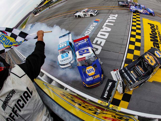 TALLADEGA, ALABAMA - OCTOBER 04: Daniel Dye, driver of the #43 NAPA Nightvision Chevrolet, Christian Eckes, driver of the #19 NAPA Auto Care Chevrolet, and Ryan Reed, driver of the #91 Tandem Diabetes Care Chevrolet, spin after an on-track incident to end the NASCAR Craftsman Truck Series Love's RV Stop 225 at Talladega Superspeedway on October 04, 2024 in Talladega, Alabama.   Sean Gardner/Getty Images/AFP (Photo by Sean Gardner / GETTY IMAGES NORTH AMERICA / Getty Images via AFP)