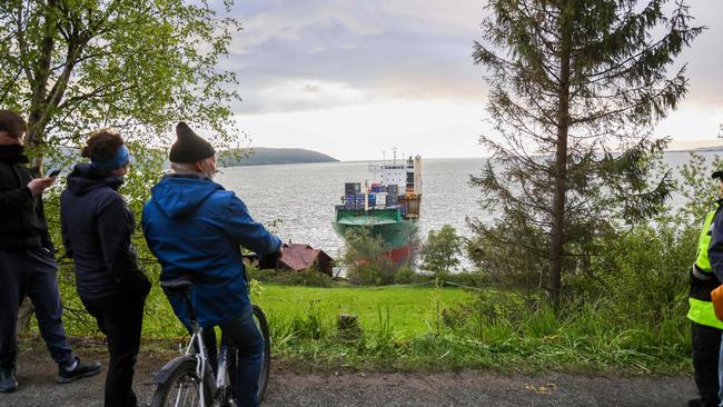 Locals flocked to the scene to see the ship metres from Mr Helberg’s home. Picture: Jan Langhaug / NTB / AFP