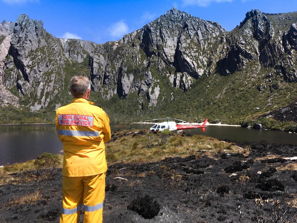 NSW Rural Fire Service personnel assisting with fighting the fire at Lake Rhona in Tasmania’s south-west. Picture: NSW RURAL FIRE SERVICE / ANDREW MACDONALD