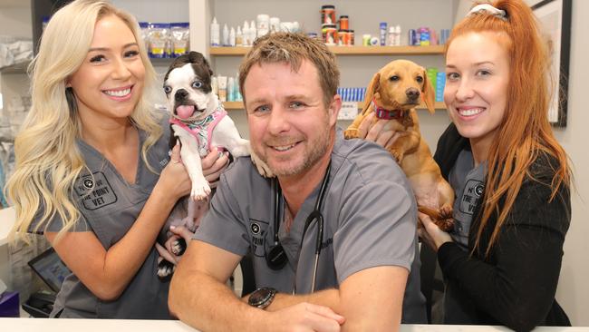 The Point Vet owner and head vet Dr John Rigley, with Boston terrier Daphne and dachshund Stanley, and vet nurses Tess Nolan (left) and Summah Woods (right). Picture: Glenn Hampson