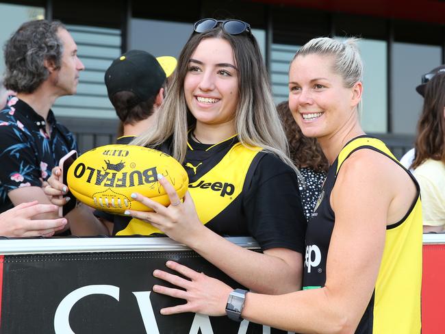 MELBOURNE, AUSTRALIA - DECEMBER 17: Katie Brennan of the Tigers is seen posing with a fan after a Richmond Tigers AFL/AFLW training session at Punt Road Oval on December 17, 2019 in Melbourne, Australia. (Photo by Mike Owen/AFL Photos/Getty Images)