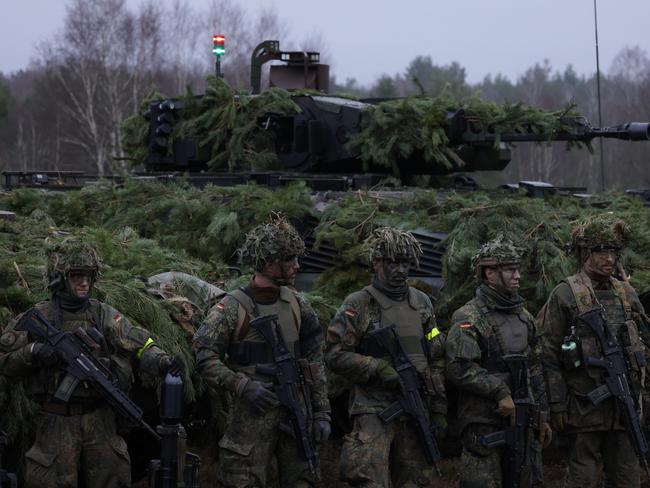 MOECKERN, GERMANY - JANUARY 26: Infantry soldiers of the Bundeswehr, the German armed forces, stand in front of a Puma infantry fighting vehicle of Panzergrenadierbataillon 122, a mechanized infantry unit, during a visit by German Defence Minister Boris Pistorius at Altengrabow on January 26, 2023 near Moeckern, Germany. Germany has given the green light to supplying Ukraine with heavy tanks. (Photo by Sean Gallup/Getty Images)