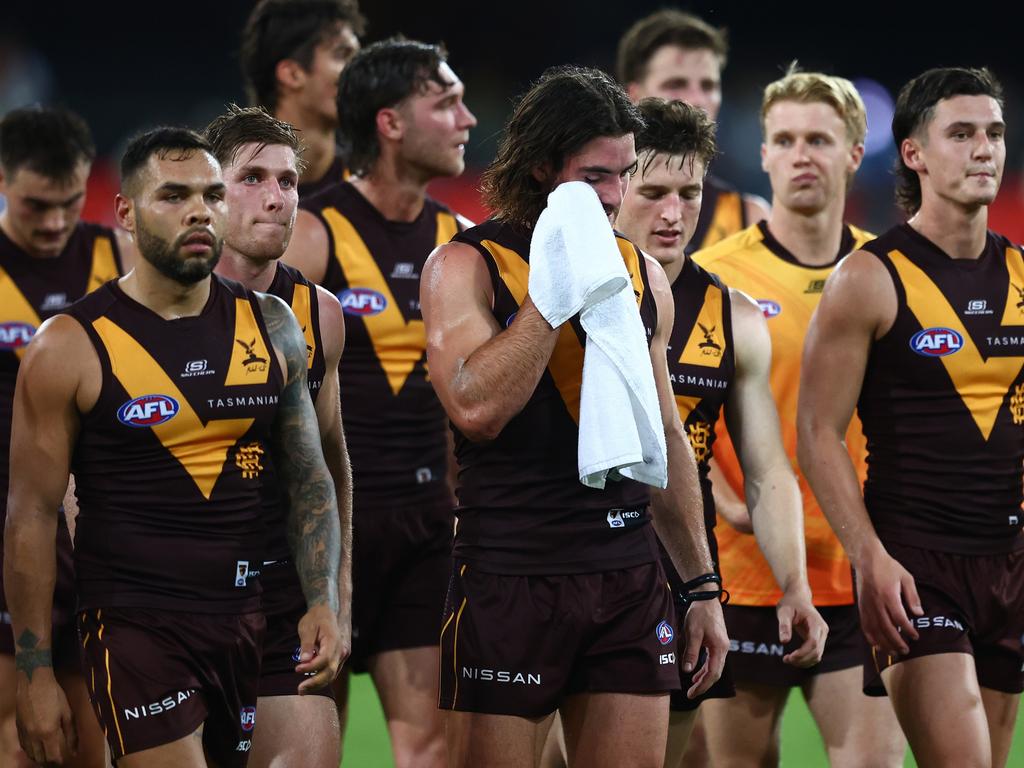 Hawks players leave the field after their loss to the Gold Coast on Saturday night. Picture: Chris Hyde/Getty Images.