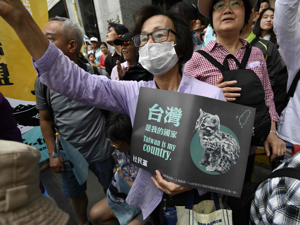 Pro-Taiwan independence activists call for the referendum on the streets in front of the headquarters of the ruling Democratic Progressive Party (DPP) during a demonstration in Taipei. Picture: AFP