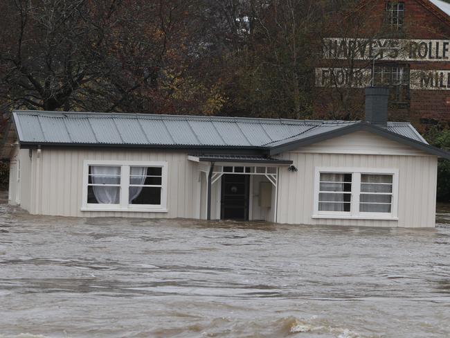 The Meander River menaces a house at Deloraine. Picture: BRUCE MOUNSTER