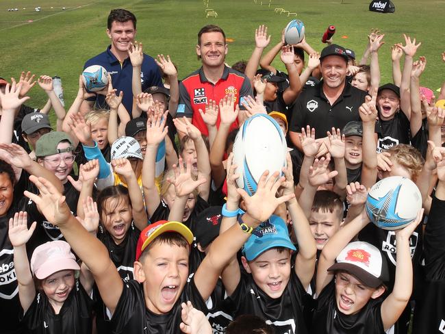 Little Rebel rookies meet Beau Fermor (titans) James Tsitas (Suns) and Matt Orford (Manly and Storm),at the Rebel school holiday training clinic at Pizzey Park . Picture Glenn Hampson