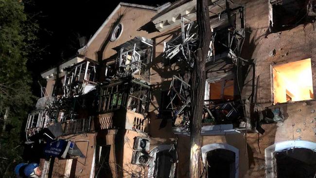 Rescuers standing close to a destroyed building, following missile strike in Zaporizhzhia. Picture: AFP