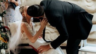 Ashleigh and Jason share their first kiss as husband and wife after their intimate wedding at Sea World Resort, organised by Gold Coast Girls In Business.