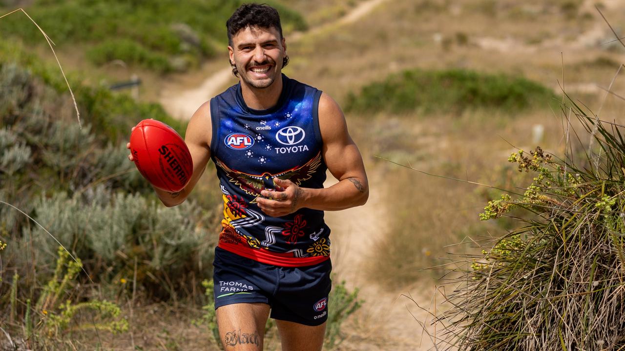 Izak Rankine in the Crows Indigenous jumper he designed. Picture: Sarah Reed Photography