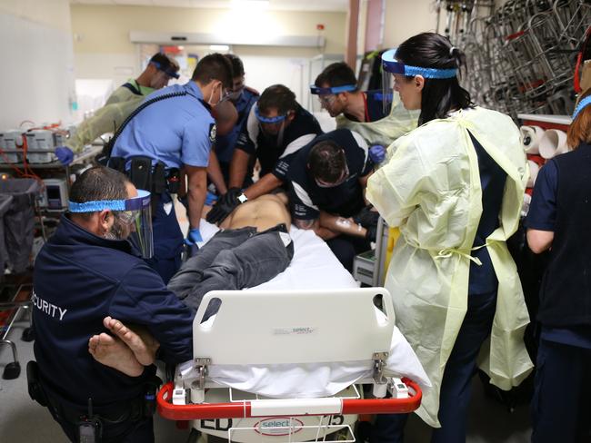 An ice user in a state of psychosis is treated by emergency medical staff in hospital. Picture: Gary Ramage