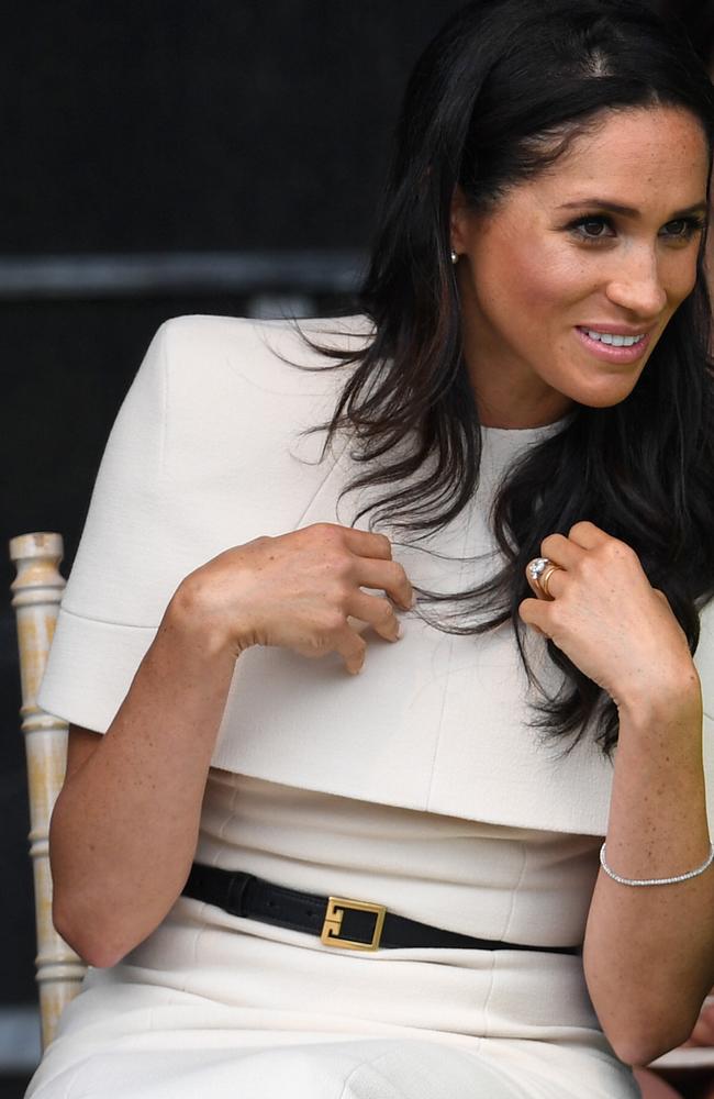 Meghan, Duchess of Sussex, smiles as she sits next to Queen Elizabeth II. Picture: Getty