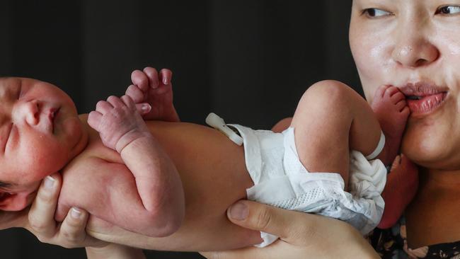 Newborns having heel prick test for story about new heel pick blood test being offered to Victorian newborn. Mum Quyen Khajavee kisses new born daughter Sahar Khajavee after a heel prick test at the Joan Kirner Womens and Childrens Hospital.                                                              Picture: David Caird