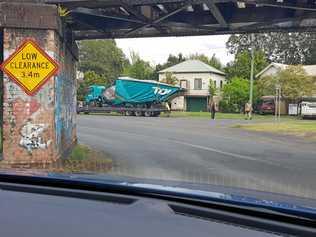 TRUCK SQUEEZE: A truck driver had a lucky escape when their vehicle failed to pass under a low bridge in South Lismore on Wednesday. Picture: Supplied