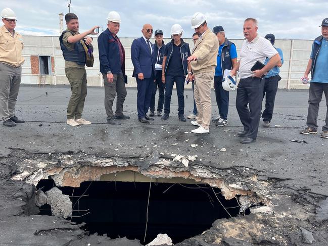 The IAEA team with IAEA Chief Rafael Grossi (C) observing the damage caused by shelling on the roof of the special building at the Zaporizhzhia Nuclear Power Plant. Picture: AFP