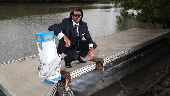 Travers Beynon, AKA The Candyman, on his pontoon at his home that council won’t let him put back after repairs. Picture Glenn Hampson