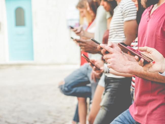 Group of friends watching smart mobile phones - Teenagers addiction to new technology trends - Concept of youth, tech, social and friendship - Focus on close-up phone