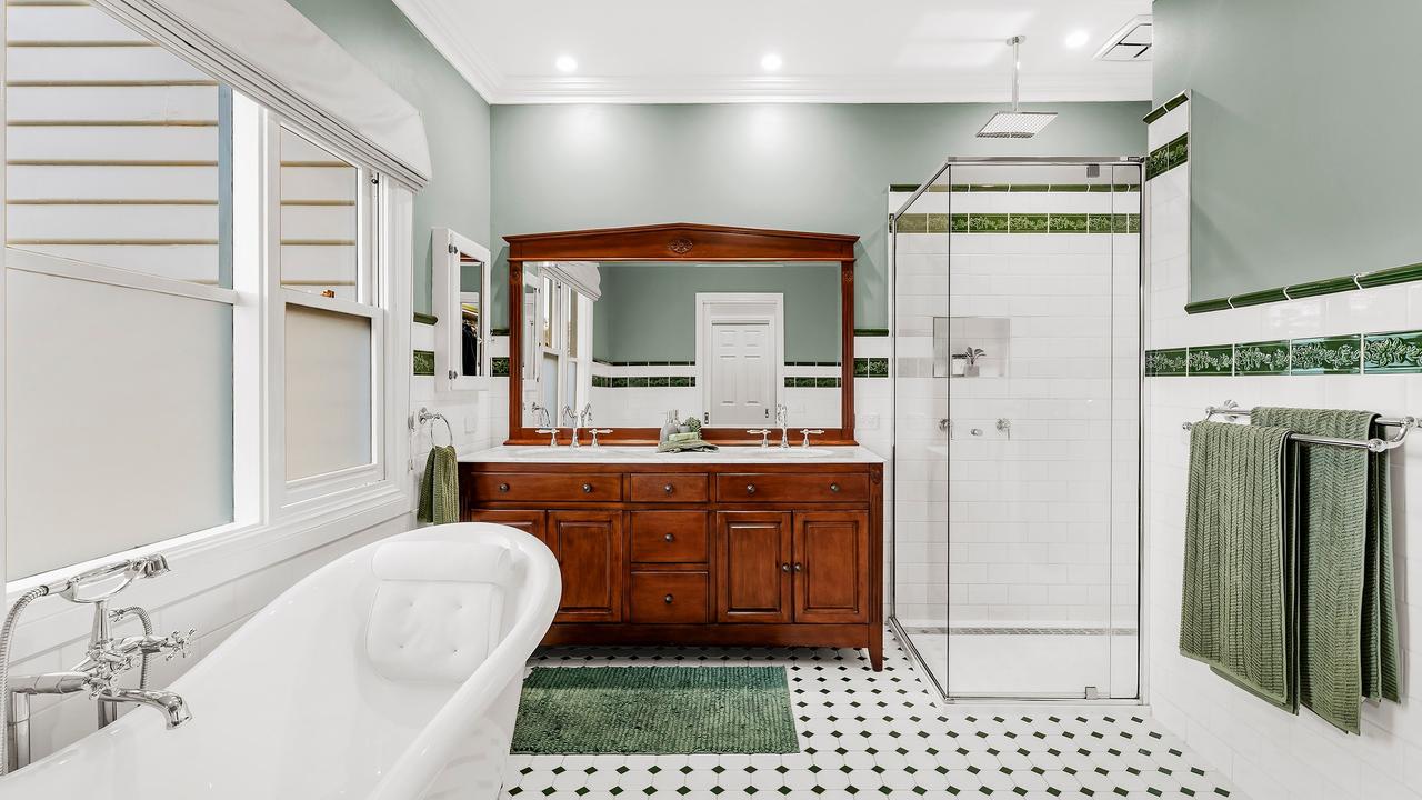 A bathtub and shower in one of the two bathrooms.