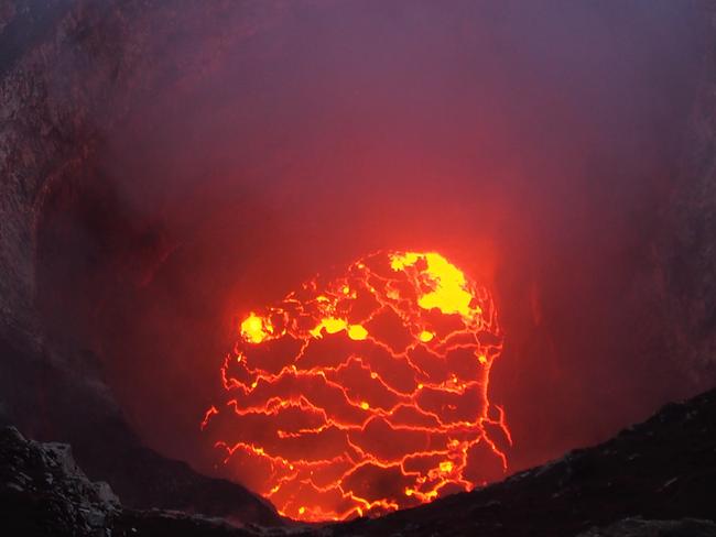 These dramatic images and videos capture the devastation caused by the Kilauea volcano, which erupted in a small community of Hawaii s Big Island. The volcano began spewing molten rock, lava and toxic gas and has so far destroyed 35 homes and buildings and forced 1,700 people to evacuate in the Leilani Estates area since it erupted on Thursday [May 3]. Some of the evacuated residents were allowed to return to their homes briefly on Sunday [May 6] to attempt to rescue pets and gather necessities. Authorities have said residents will be allowed to return to their homes each day only if it is deemed safe. Many residents living in the idyllic paradise of Leilani Estates, which is in the Puna District, are not able to buy homeowners insurance on account of living on top of an active volcano. Lava flows have engulfed homes, cars, streets and trees. An alert remains on the Hawaii County Civil Defense Agency s website, warning residents:  Be prepared to evacuate at a moment's notice.  On Monday [May 7] residents in a another community, Lanipuna Gardens, were not allowed to return home due to deadly volcanic gasses. It came after a new fissure opened up on Sunday, spewing sulfur dioxide gas which can be deadly in high levels. No deaths or major injuries have been reported as yet. 07 May 2018 Pictured: The Kilauea volcano in Hawaii s Big Island has caused the evacuation of 1,700 residents and so far destroyed 35 homes and buildings since erupting on May 3, 2018. LOCAL CAPTION: This very wide angle camera view captures the entire north portion of the Overlook crater on May 6. Photo credit: USGS/ MEGA  TheMegaAgency.com +1 888 505 6342