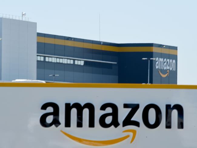 (FILES) In this file photo taken on May 19, 2020  in Bretigny-sur-Orge on May 19, 2020 shows a sign with the company's logo at Amazon's centre entrance as Amazon France partially reopens amid the pandemic of the novel coronavirus (COVID-19). - Amazon on September 29, 2020, defended its warehouse safety record after a news investigation pointed to a higher-than-average injury rate in the company's massive logistics operations. (Photo by ERIC PIERMONT / AFP)