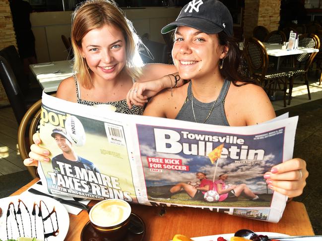 Friends Kjara Heese, 20 and Benedetta Turetta, 20 read the Townsville Bulletin on The Strand whilst having breakfast Picture: Zak Simmonds