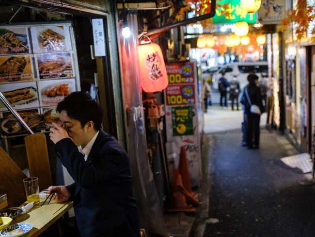 A man drinks at a restaurant in Tokyo’s Shinjuku district. Picture: AFP