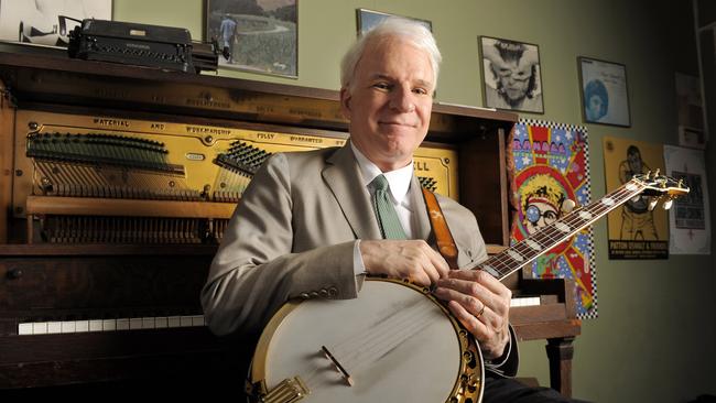 Actor, musician and writer Steve Martin poses with his banjo backstage before an appearance with the Steep Canyon Rangers band at Largo at the Coronet Theatre in Los Angeles, California in 2010. (AP Photo/Chris Pizzello)