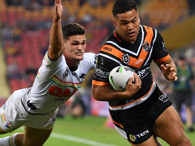 Esan Marsters (right) of the Tigers scores a try in the corner despite the efforts of Nathan Cleary (left) of the Panthers during the Round 9 NRL match between the Wests Tigers and the Penrith Panthers at Suncorp Stadium in Brisbane, Friday, May 10, 2019.  (AAP Image/Darren England) NO ARCHIVING, EDITORIAL USE ONLY