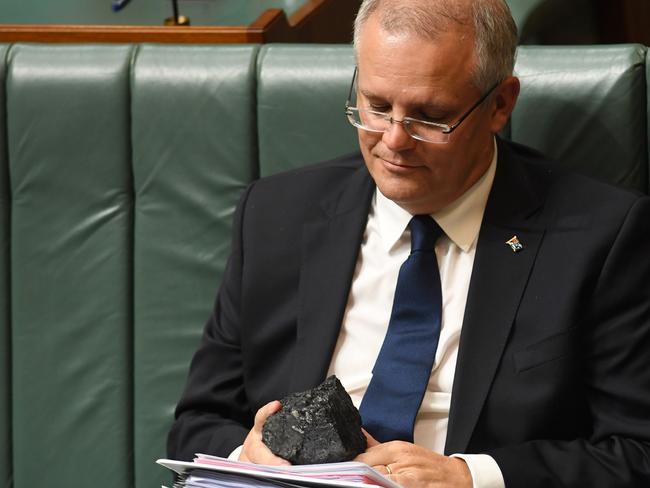 Australia's Treasurer Scott Morrison looks at a piece of coal during Question Time. Picture: AAP